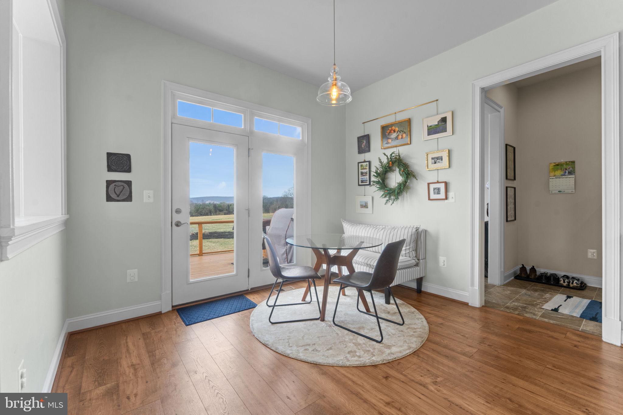 16756 Misty Ridge Lane Purcellville, VA 20132 - Photo 33 of 92 a view of a dining room with furniture and wooden floor