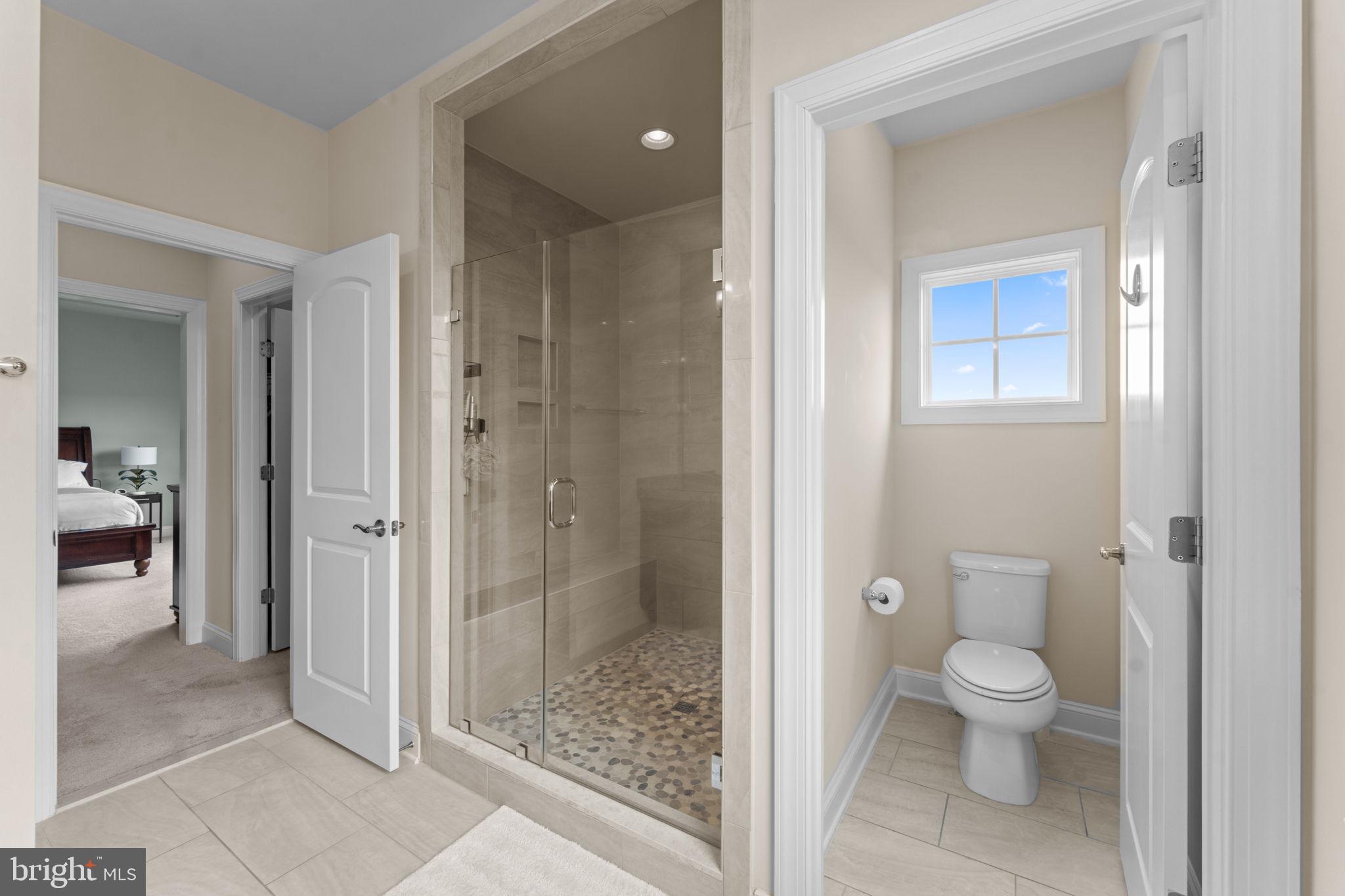 16756 Misty Ridge Lane Purcellville, VA 20132 - Photo 46 of 92 a bathroom with a granite countertop toilet a sink and shower