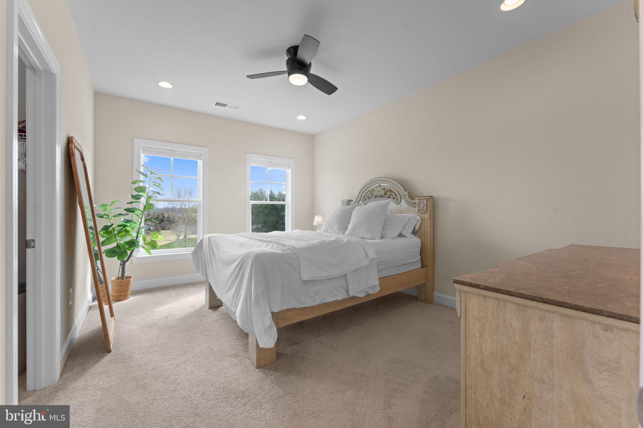 16756 Misty Ridge Lane Purcellville, VA 20132 - Photo 52 of 92 a bedroom with a bed and a couch