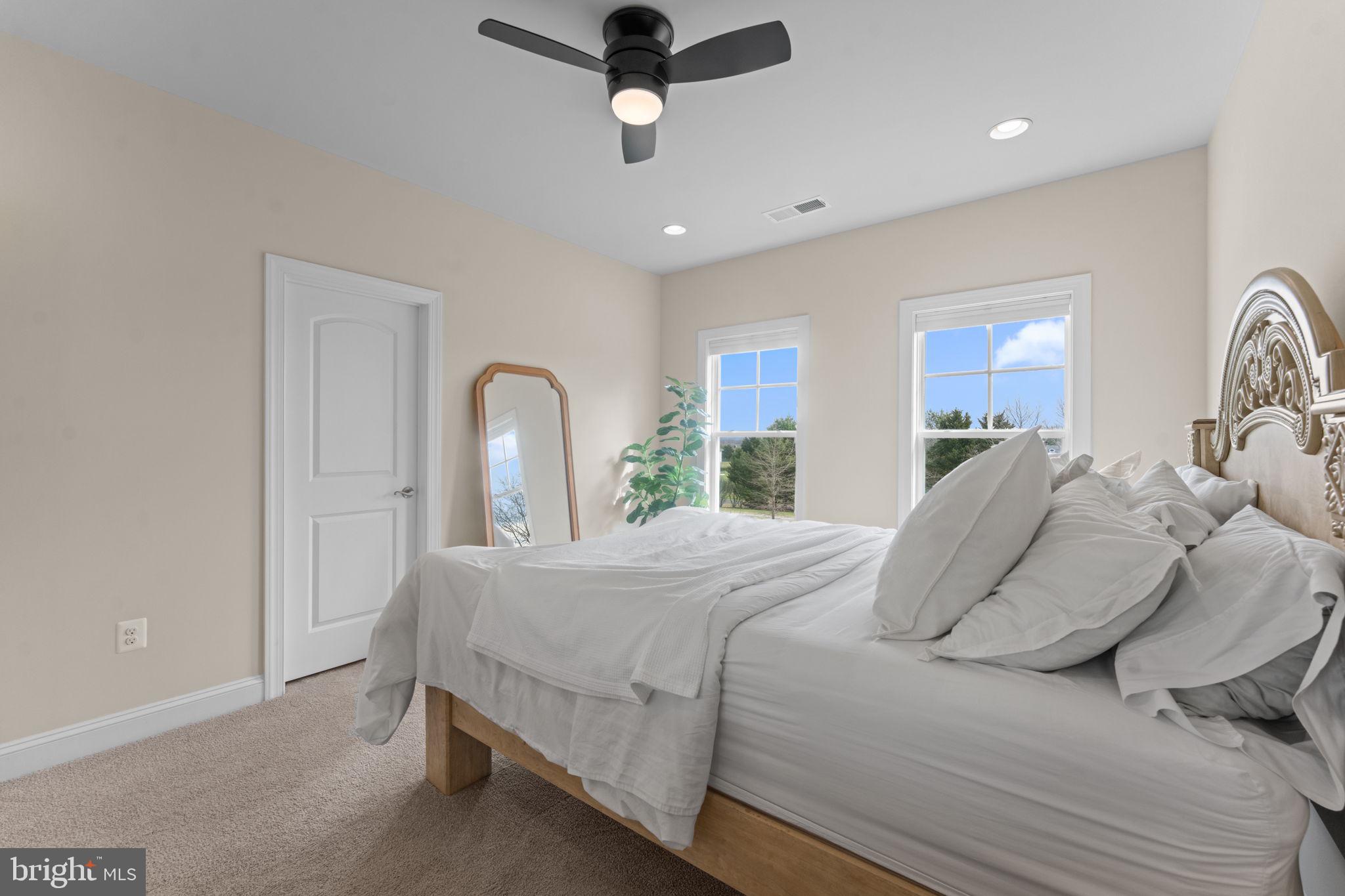 16756 Misty Ridge Lane Purcellville, VA 20132 - Photo 53 of 92 a bedroom with a bed ceiling fan and a window