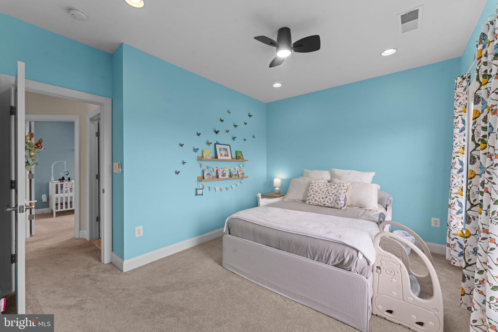 16756 Misty Ridge Lane Purcellville, VA 20132 - Photo 60 of 92 a bedroom with a large bed and a chandelier