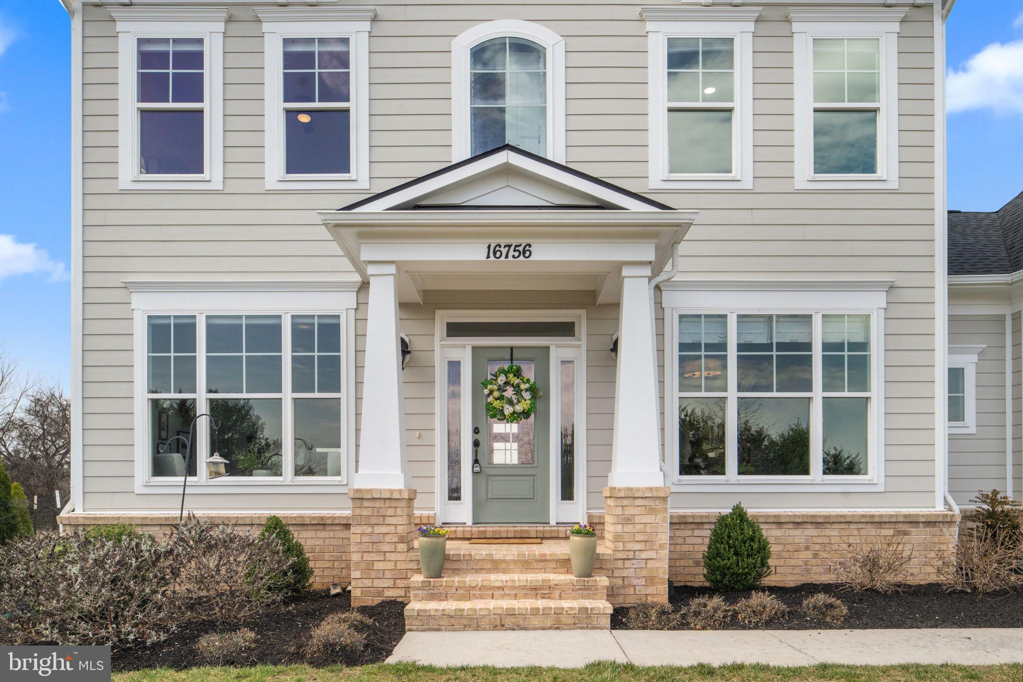 16756 Misty Ridge Lane Purcellville, VA 20132 - Photo 7 of 92 a front view of a house with a yard and glass windows