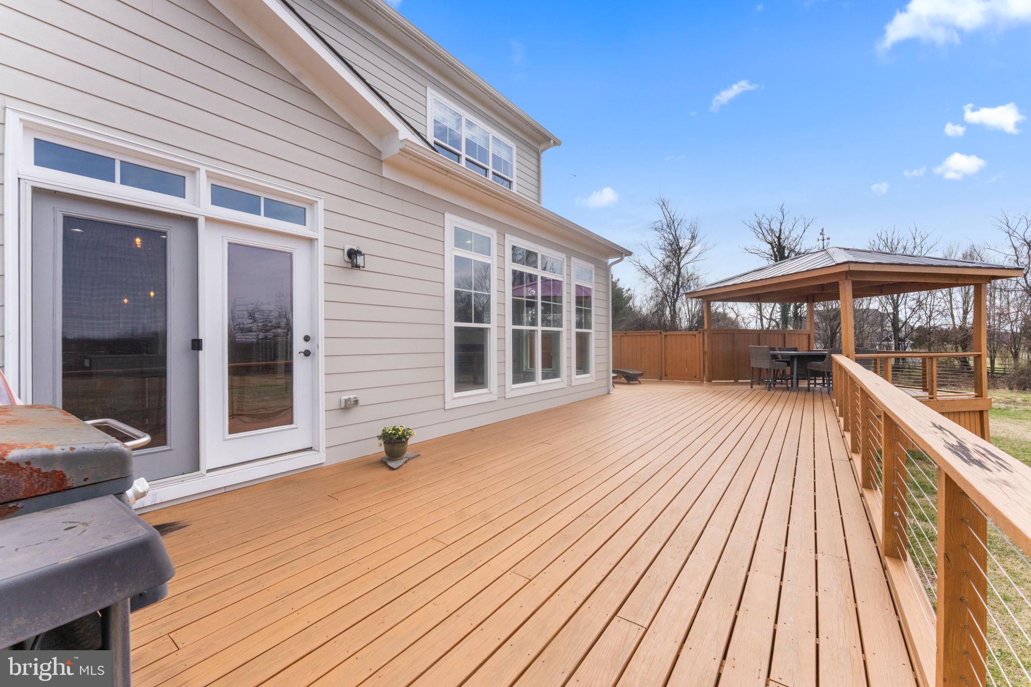 16756 Misty Ridge Lane Purcellville, VA 20132 - Photo 71 of 92 a view of a house with a barbeque and wooden stairs