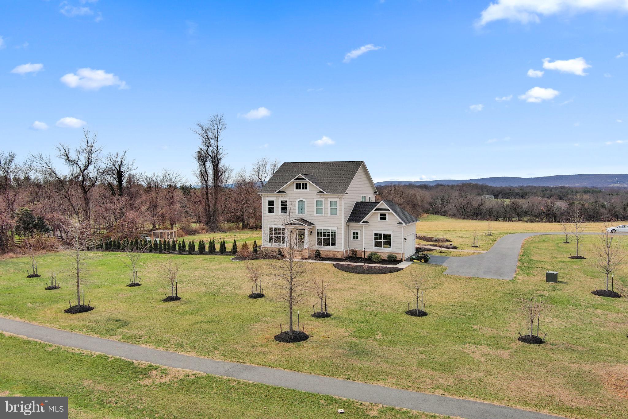 16756 Misty Ridge Lane Purcellville, VA 20132 - Photo 86 of 92 a view of a lake with a yard
