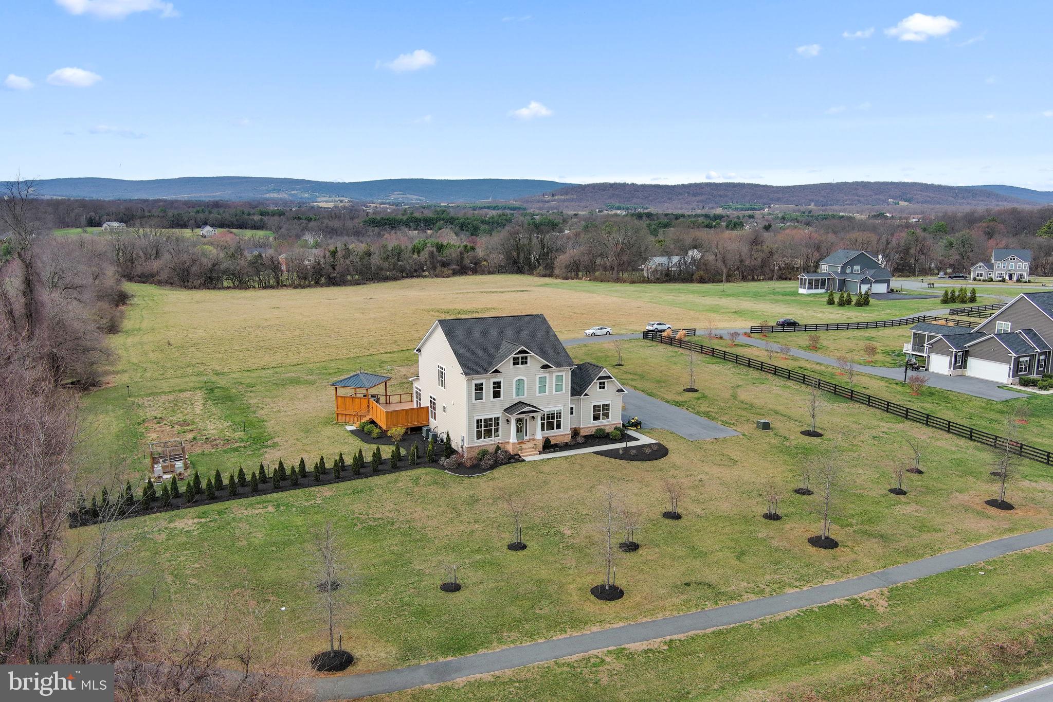 16756 Misty Ridge Lane Purcellville, VA 20132 - Photo 88 of 92 a view of a lake with a mountain in the background