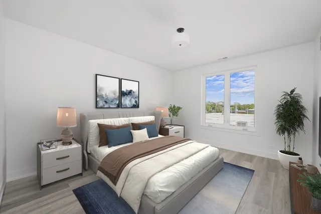 a bedroom with a bed and a potted plant