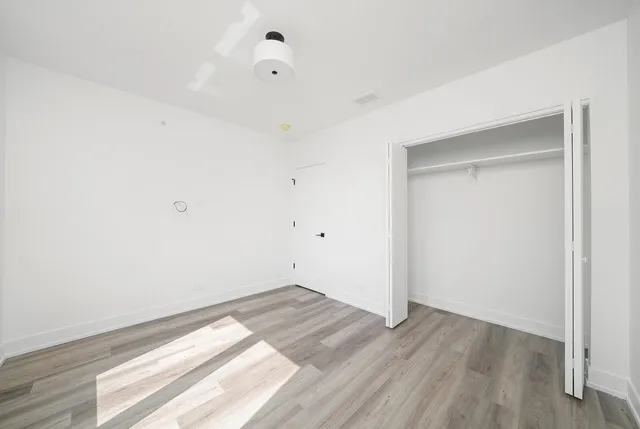 an empty room with wooden floor