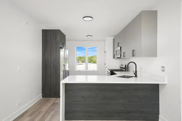 a kitchen with granite countertop a sink cabinets and window