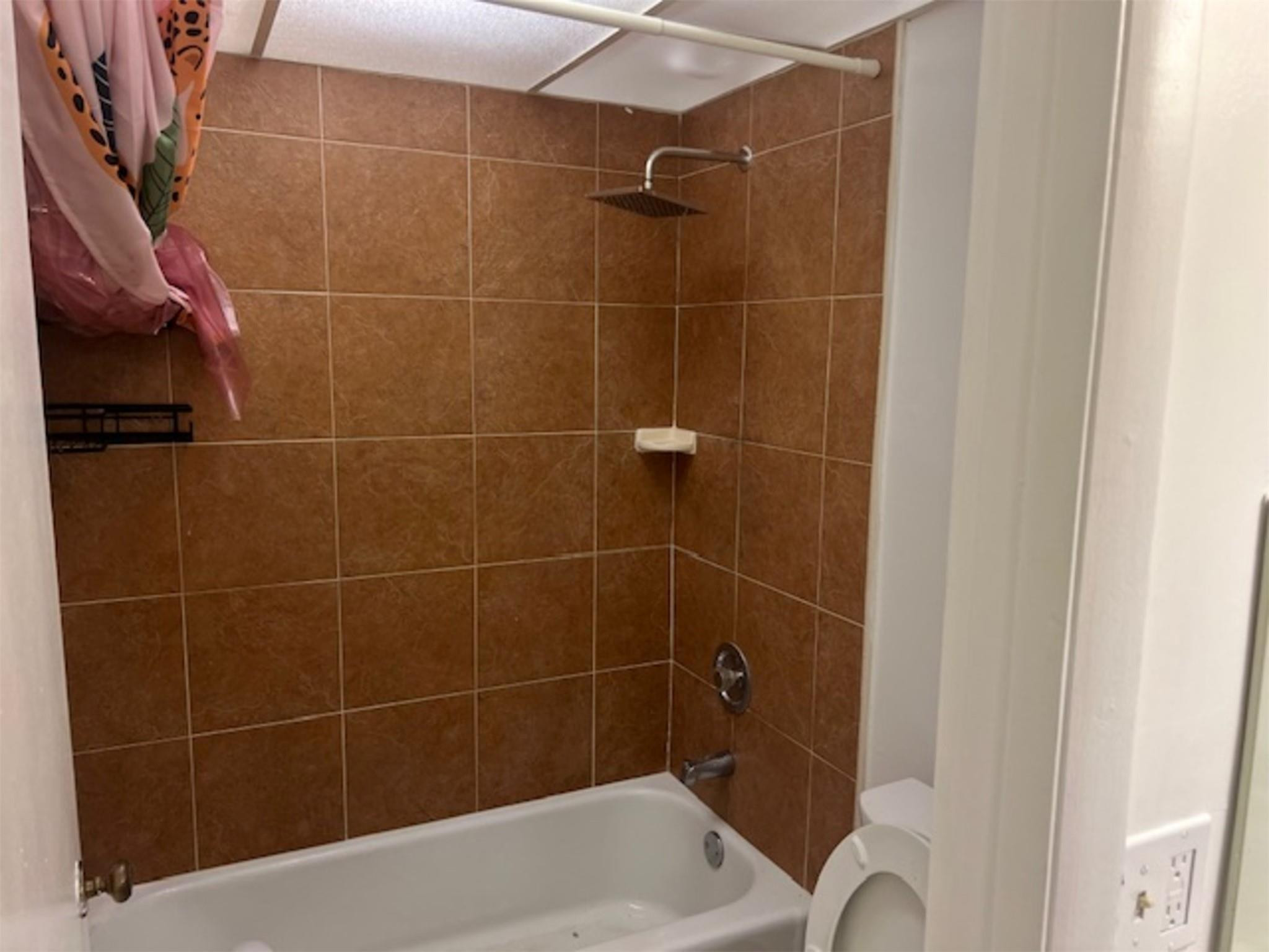 3720 Inverrary Drive, Unit 1T Lauderhill, FL 33319 - Photo 8 of 36 a bathroom with a bathtub and a shower