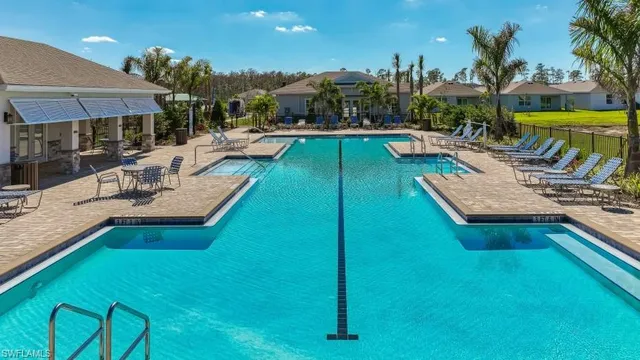 a view of a swimming pool with lounge chairs