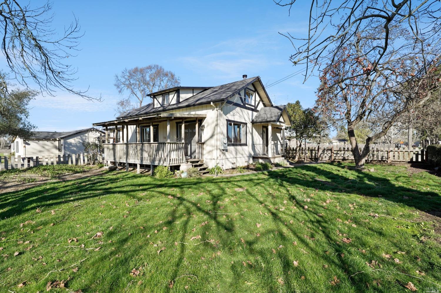 a front view of a house with a yard table and chairs