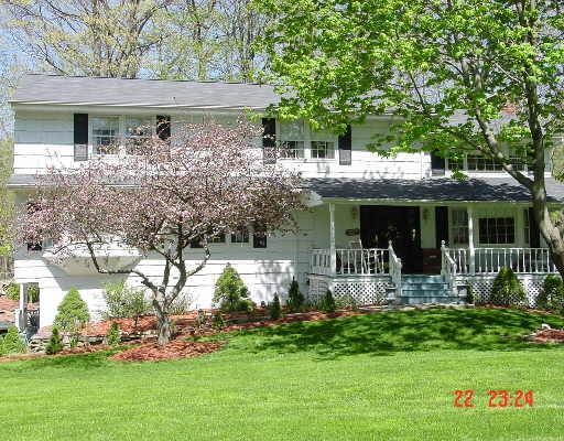 51 Remington Road Ridgefield, CT 06877 - Photo 1 of 1 a front view of house with a garden and patio