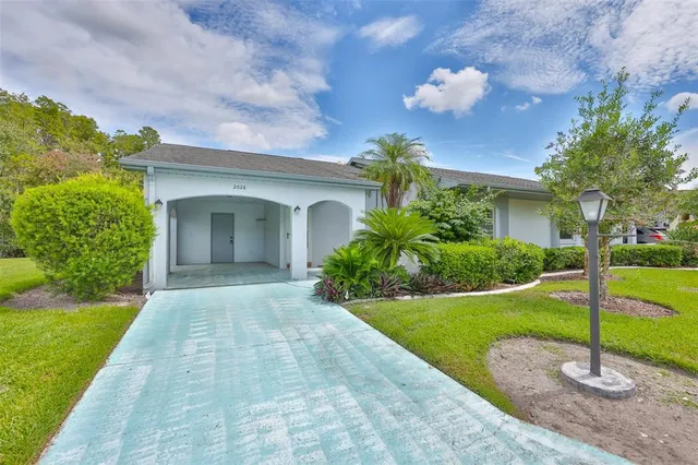 a view of a house with a yard and a garden