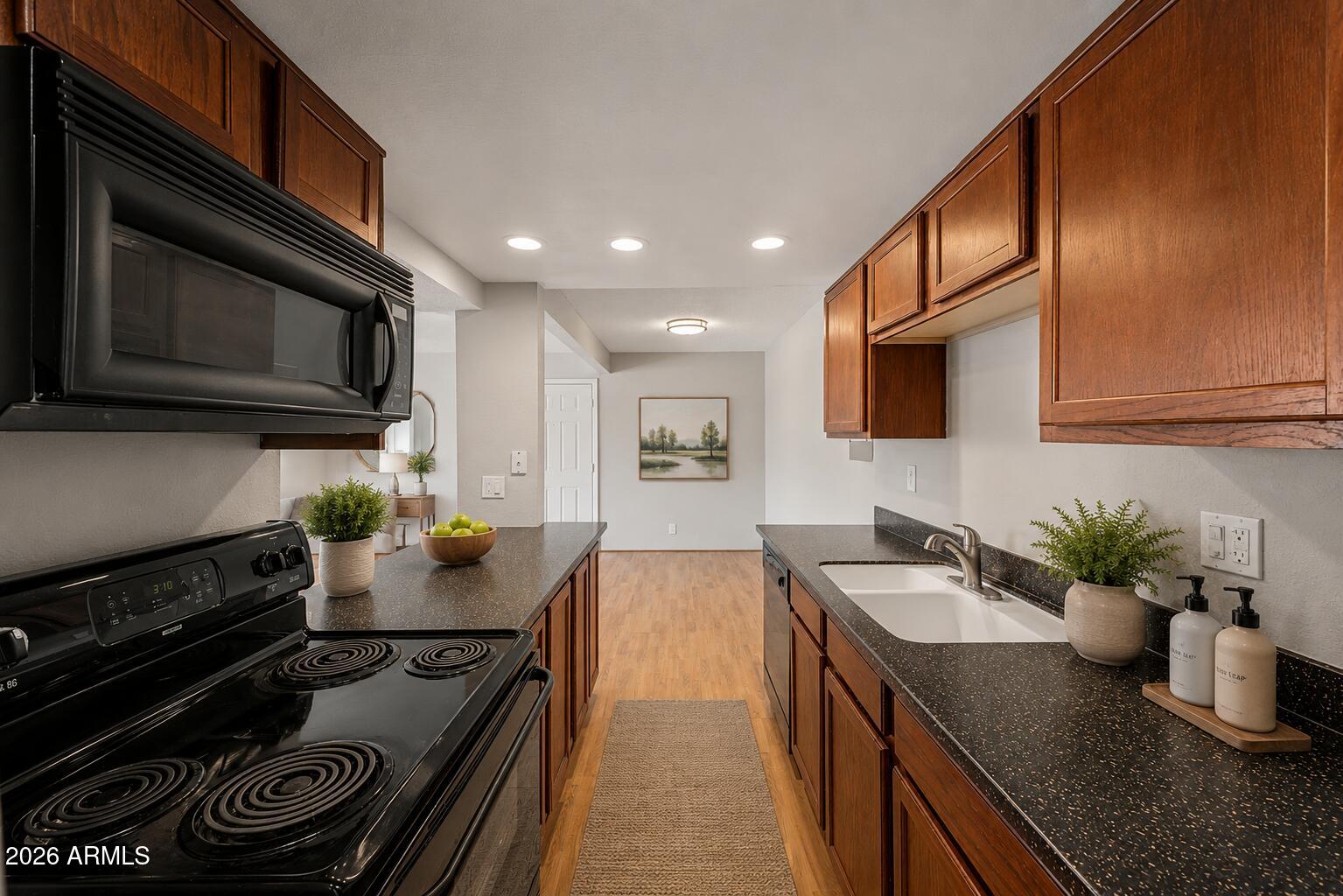 424 West Brown Road, Unit 248 Mesa, AZ 85201 - Photo 7 of 19 a kitchen with stainless steel appliances granite countertop a stove a sink and a microwave