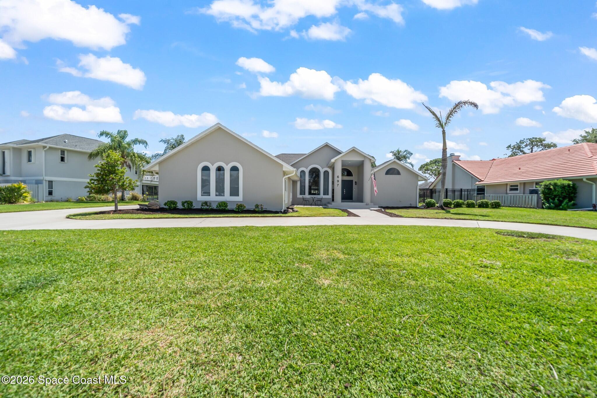 697 Spring Lake Drive Melbourne, FL 32940 - Photo 42 of 45 a front view of house with yard and green space