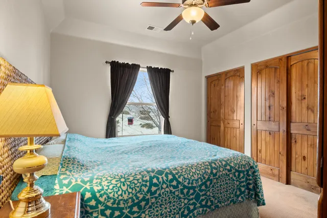 a bedroom with a bed and a window