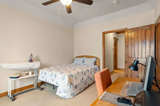 a bedroom with a bed and a chandelier