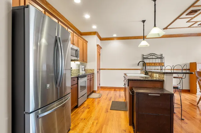 a kitchen with stainless steel appliances a refrigerator and a stove