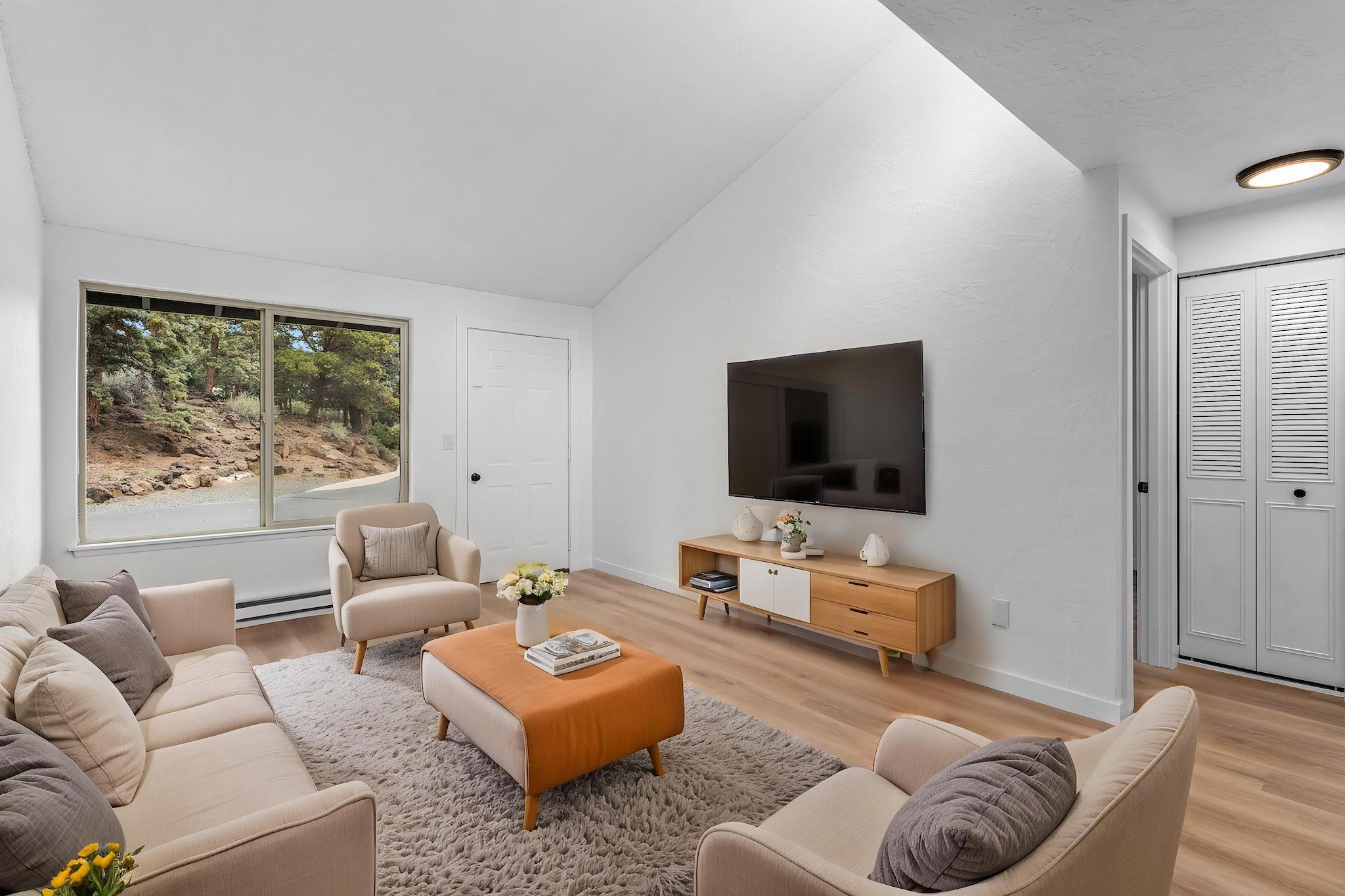 1700 Northeast Wells Acres Road, Unit 25 Bend, OR 97701 - Photo 9 of 25 a living room with furniture and a flat screen tv