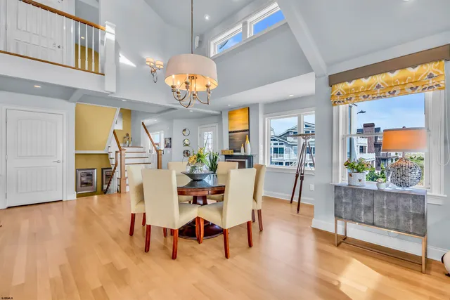 a kitchen with stainless steel appliances granite countertop a sink a stove a refrigerator and wooden floor