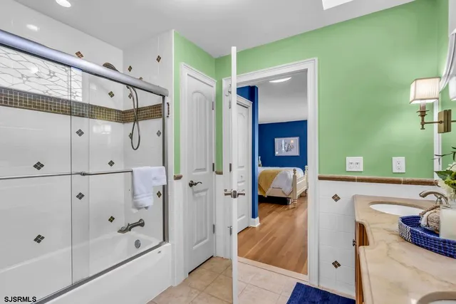 a bedroom with two beds and a flat screen tv