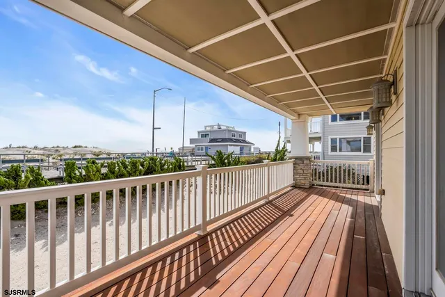 a view of a hallway with wooden floor and closet