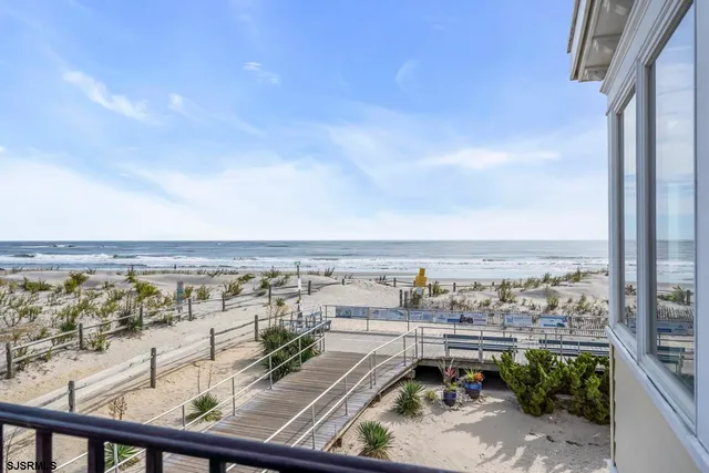 a bathroom with a granite countertop sink a mirror and a shower