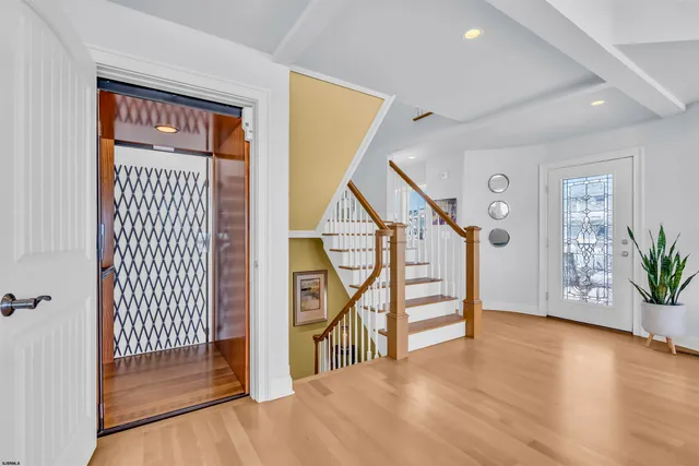 a view of an entryway with wooden floor