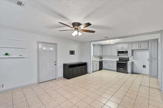 a large kitchen with cabinets and stainless steel appliances