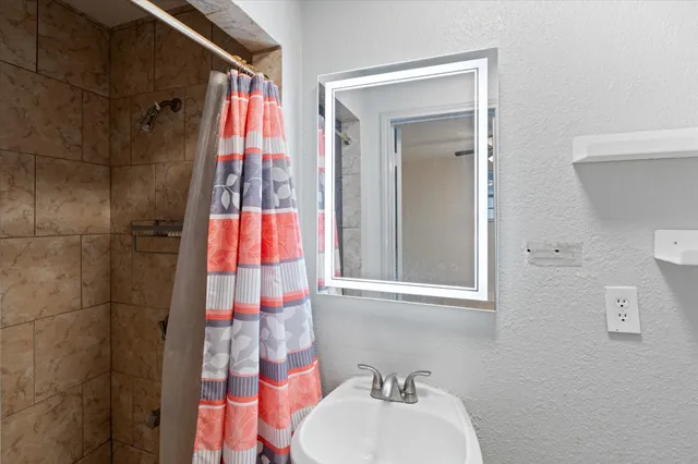 a bathroom with a sink and a mirror