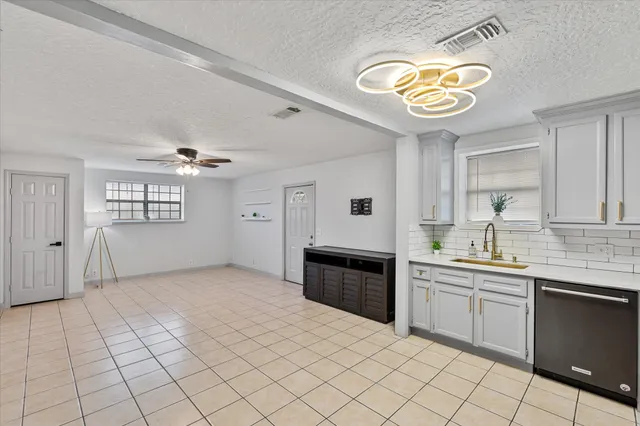 a kitchen with stainless steel appliances granite countertop a sink and cabinets