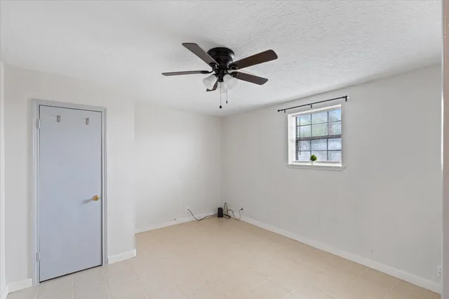 a view of a livingroom with a ceiling fan and window