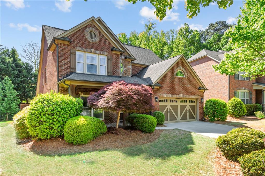 3195 Stonecrest Drive Cumming, GA 30041 - Photo 2 of 63 a front view of a house with garden