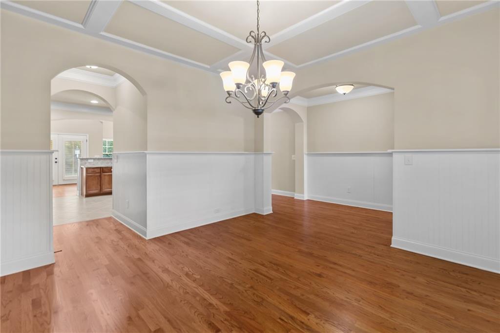 3195 Stonecrest Drive Cumming, GA 30041 - Photo 21 of 63 a view of a room with wooden floor and chandelier