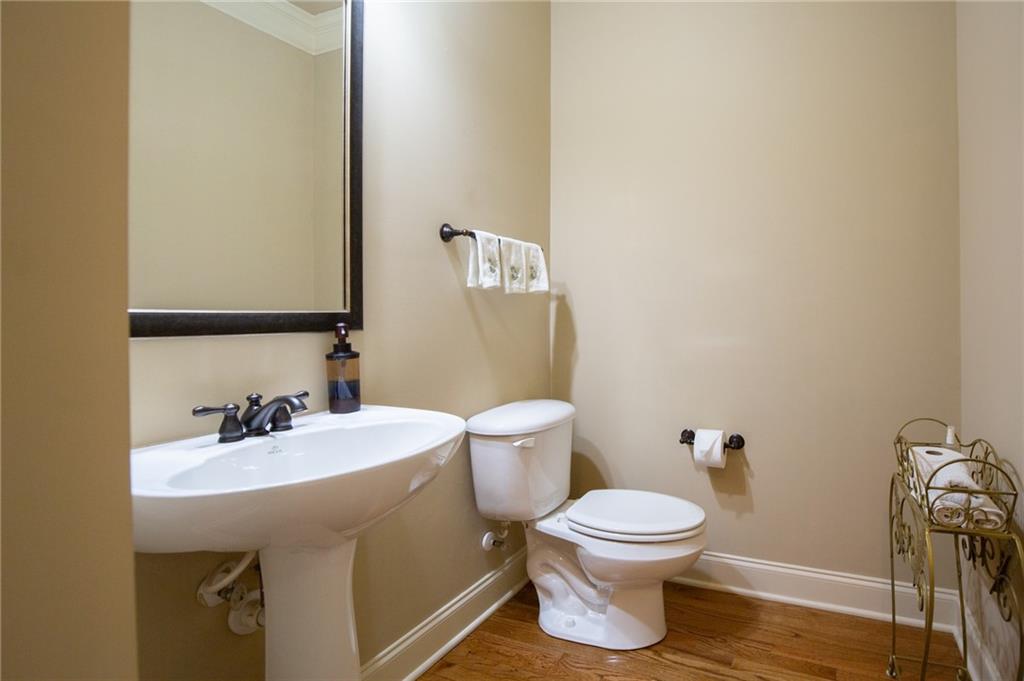 3195 Stonecrest Drive Cumming, GA 30041 - Photo 35 of 63 a bathroom with a sink a toilet and a mirror