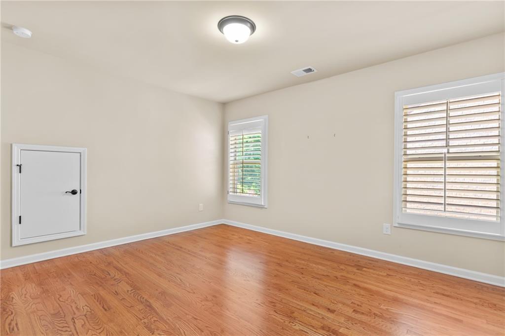 3195 Stonecrest Drive Cumming, GA 30041 - Photo 47 of 63 an empty room with wooden floor and windows