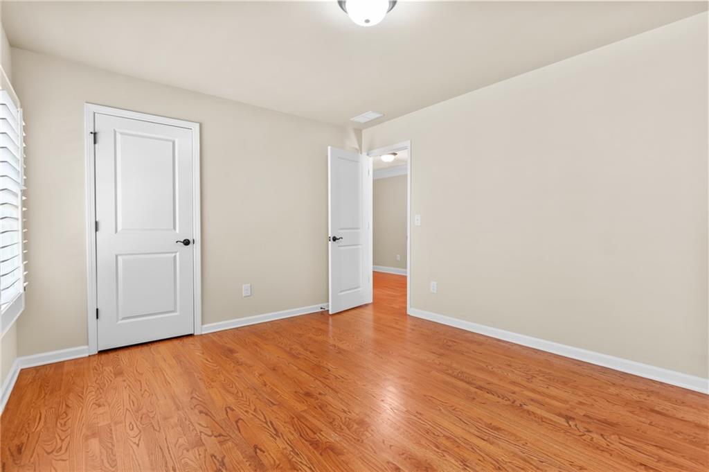 3195 Stonecrest Drive Cumming, GA 30041 - Photo 48 of 63 a view of an empty room with wooden floor