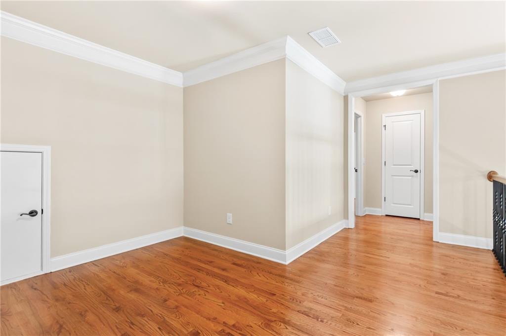 3195 Stonecrest Drive Cumming, GA 30041 - Photo 50 of 63 a view of an empty room with wooden floor