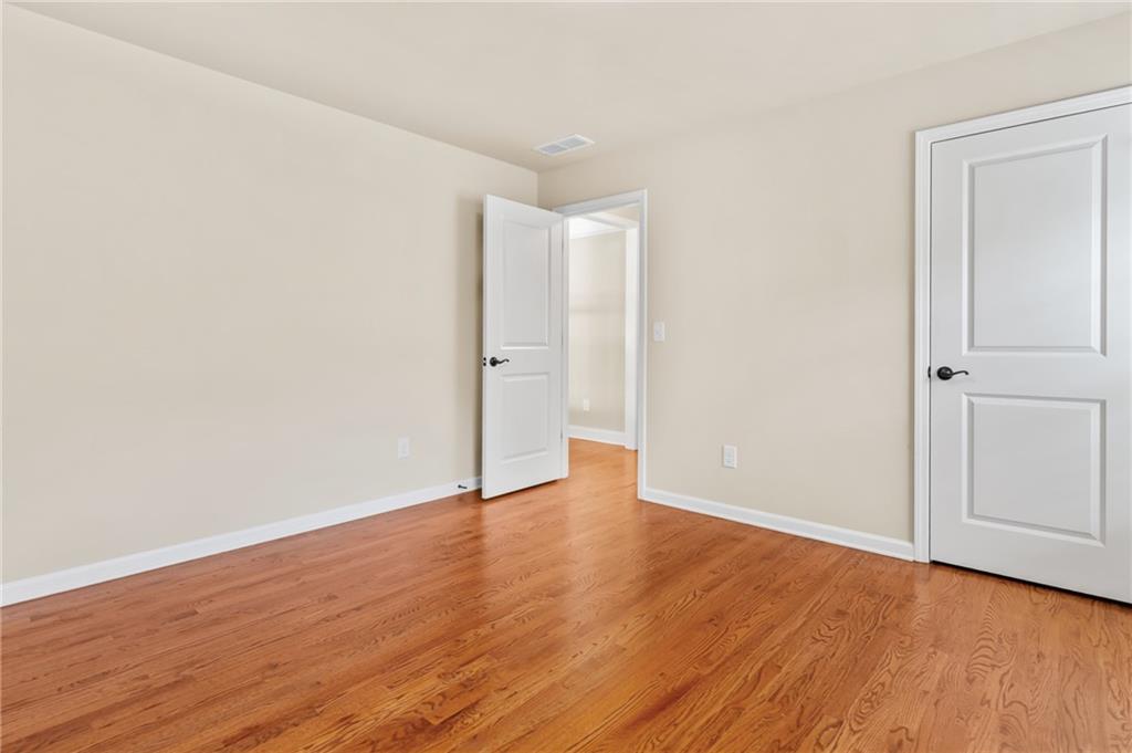 3195 Stonecrest Drive Cumming, GA 30041 - Photo 52 of 63 a view of an empty room with wooden floor