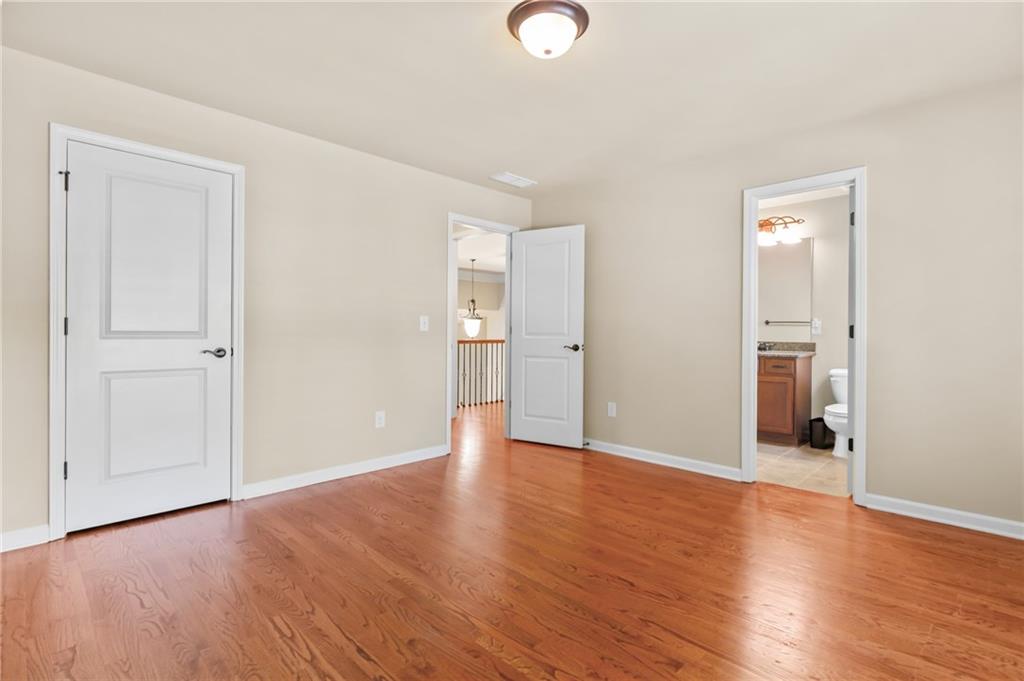 3195 Stonecrest Drive Cumming, GA 30041 - Photo 55 of 63 an empty room with wooden floor and windows