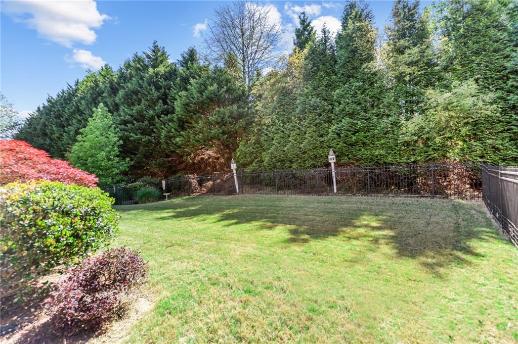 3195 Stonecrest Drive Cumming, GA 30041 - Photo 61 of 63 a view of a garden with a bench
