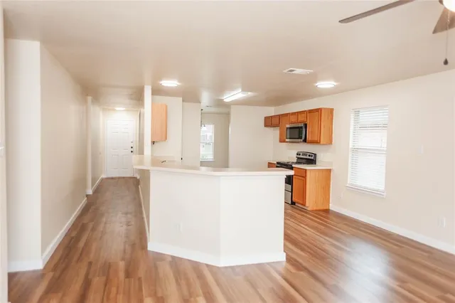 a view of kitchen with cabinets and wooden floor