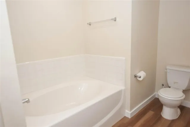 a bathroom with a bathtub and toilet