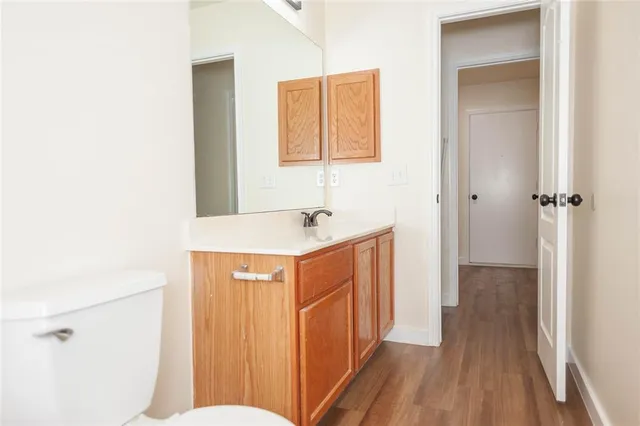 a bathroom with a sink a toilet a mirror and shower