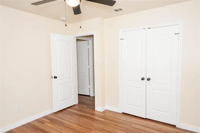 a view of a room with wooden floor