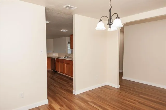 a view of a room with wooden floor and staircase