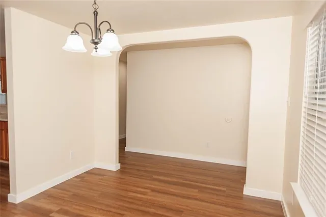 a view of a room with wooden floor