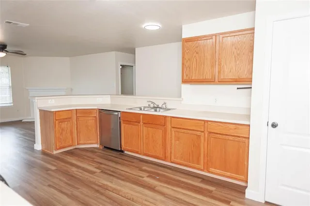 a view of a kitchen with wooden floor