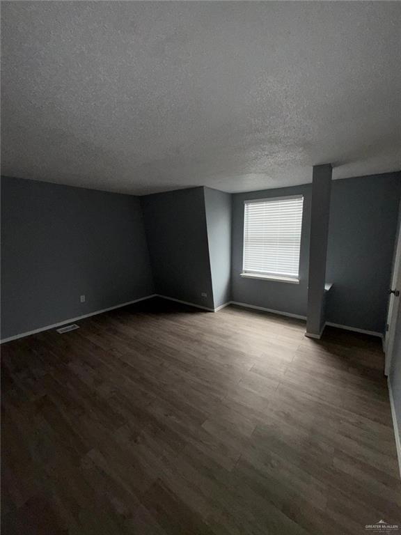 10850 Shiloh Road Dallas, TX 75228 - Photo 5 of 10 an empty room with wooden floor and windows