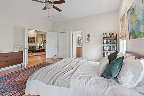 a bedroom with a large bed and a book shelf